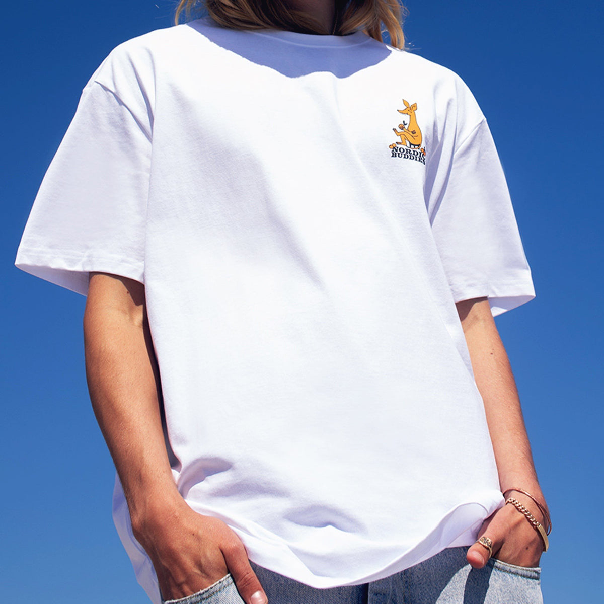 2. Unisex white Moomin by NordicBuddies t-shirt with small front logo, worn by model outdoors