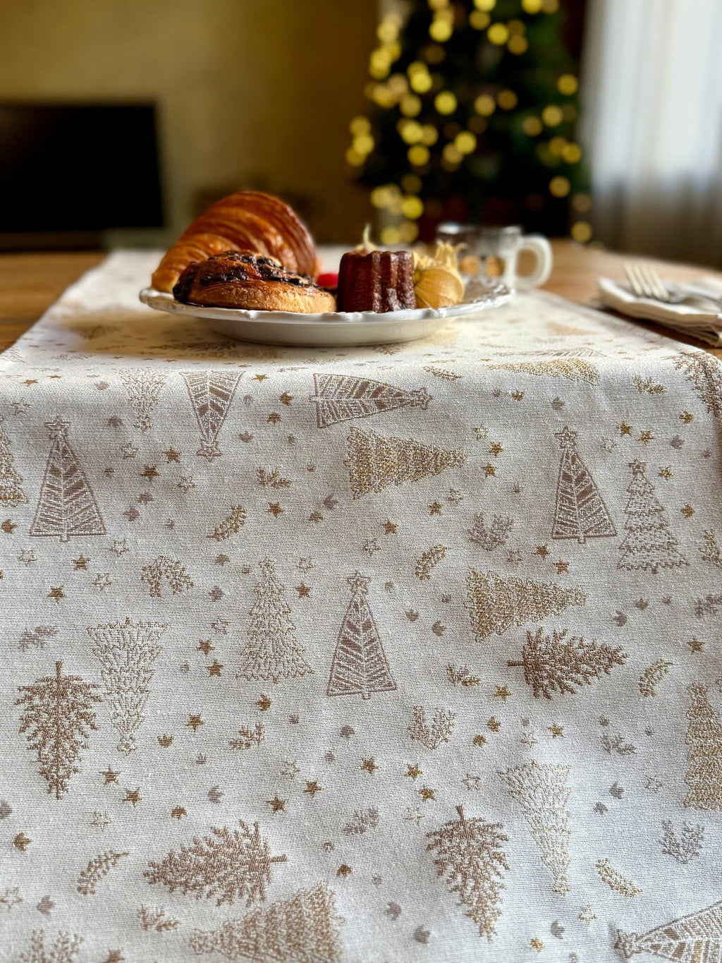 2. Close-up of Golden Forest table runner with golden tree pattern, pastries and coffee in background, highlighting fabric detail