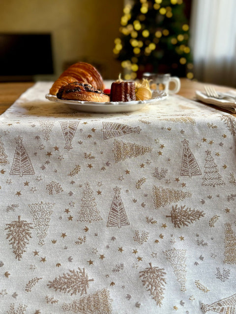 2. Close-up of Golden Forest table runner with golden tree pattern, pastries and coffee in background, highlighting fabric detail