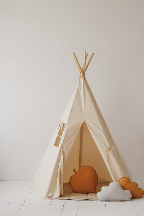1. Beige teepee tent with window and open entrance, decorated with orange and white cushions, in a studio setting