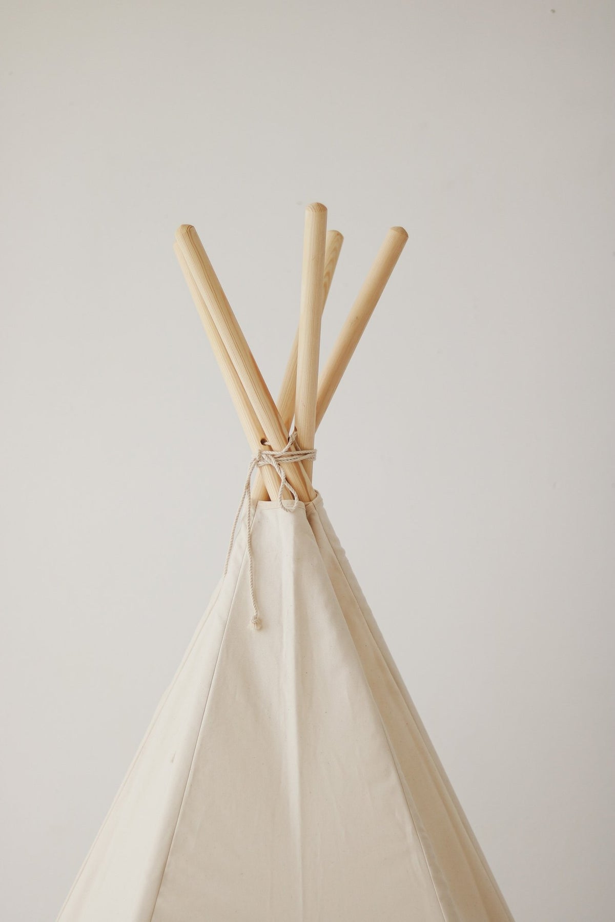 3. Close-up of beige teepee tent top with pine pole detail