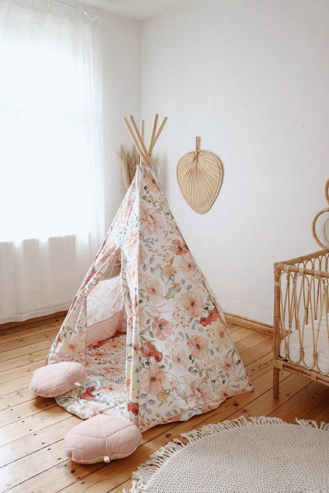 2. Floral teepee tent in a bright room with wooden floor and natural decor elements