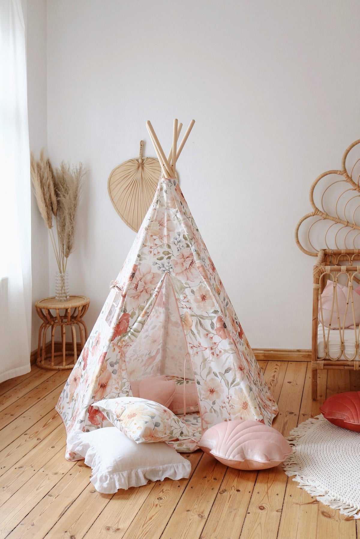 8. Floral teepee tent with pink and white cushions in a bright nursery room