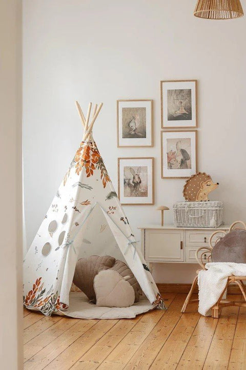 2. Cozy children's room with teepee tent featuring forest friends pattern, surrounded by framed art and wicker furniture