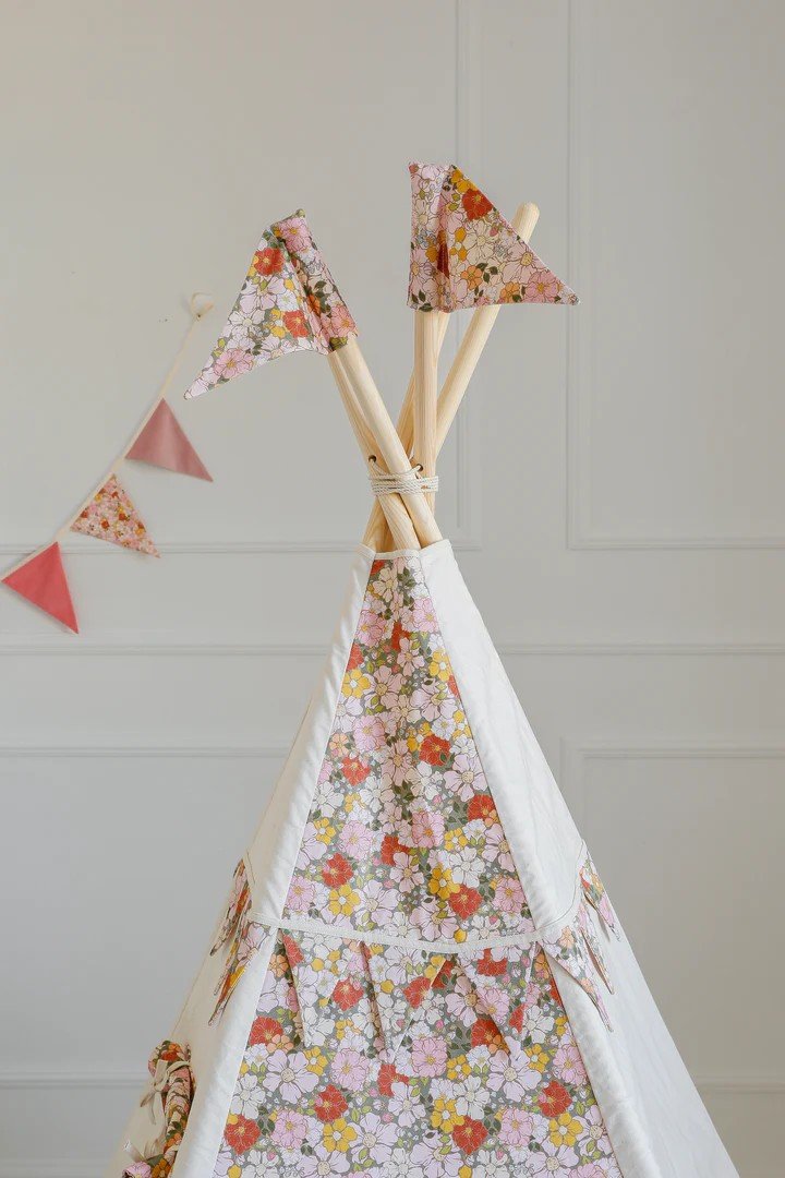 3. Close-up of top section of Moi Mili Green Garden teepee tent with floral print and decorative flags