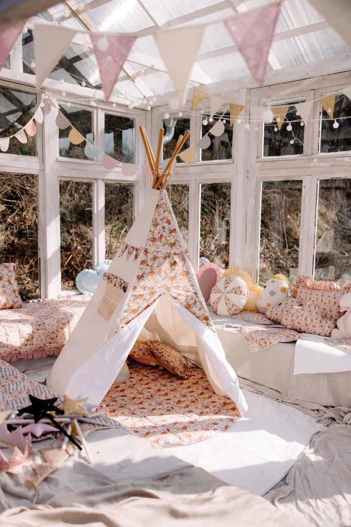 1. Moi Mili Green Garden teepee tent with floral print in a sunlit room with cushions and bunting