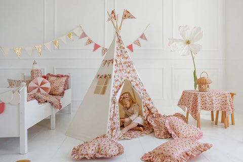 1. Child sitting inside Moi Mili Green Garden teepee tent with floral print in a decorated playroom