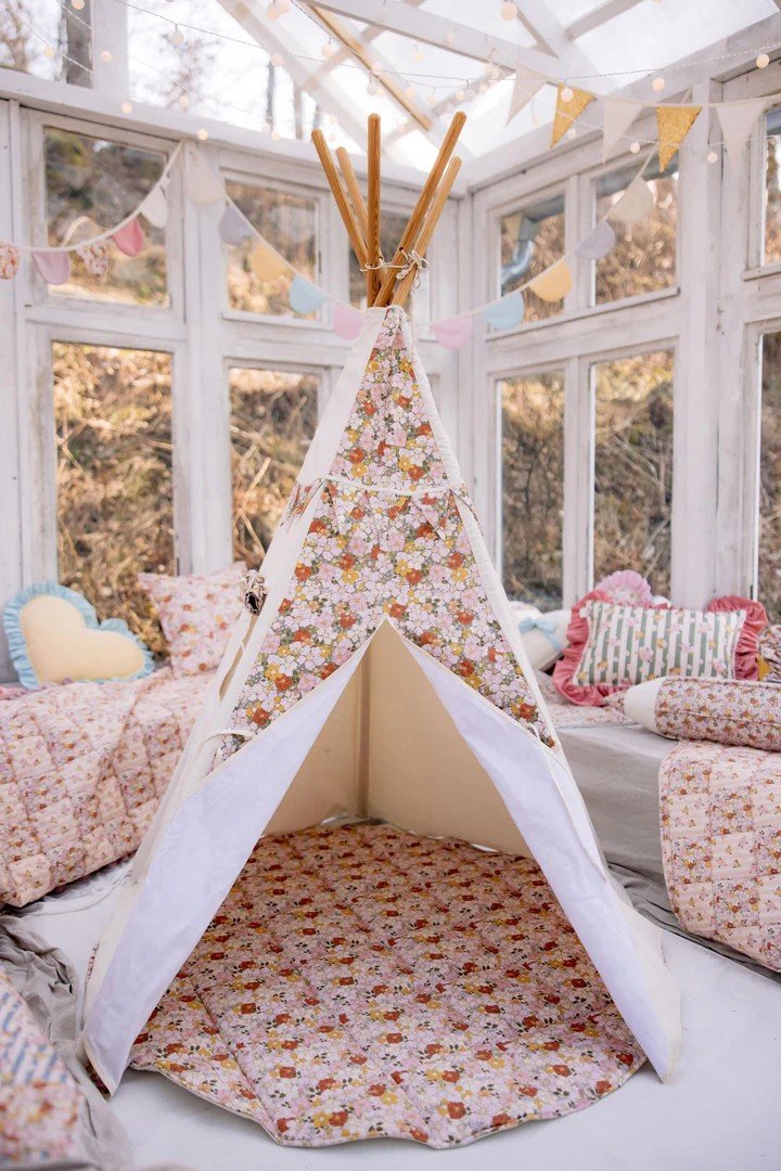 1. Moi Mili Green Garden teepee tent with floral print set up in a cozy room with cushions and bunting