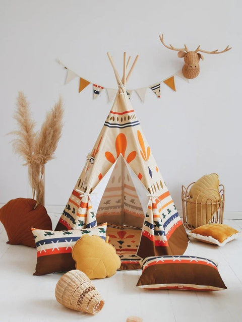 1. Teepee tent with geometric prints in a decorated room with pillows and a faux deer head on the wall