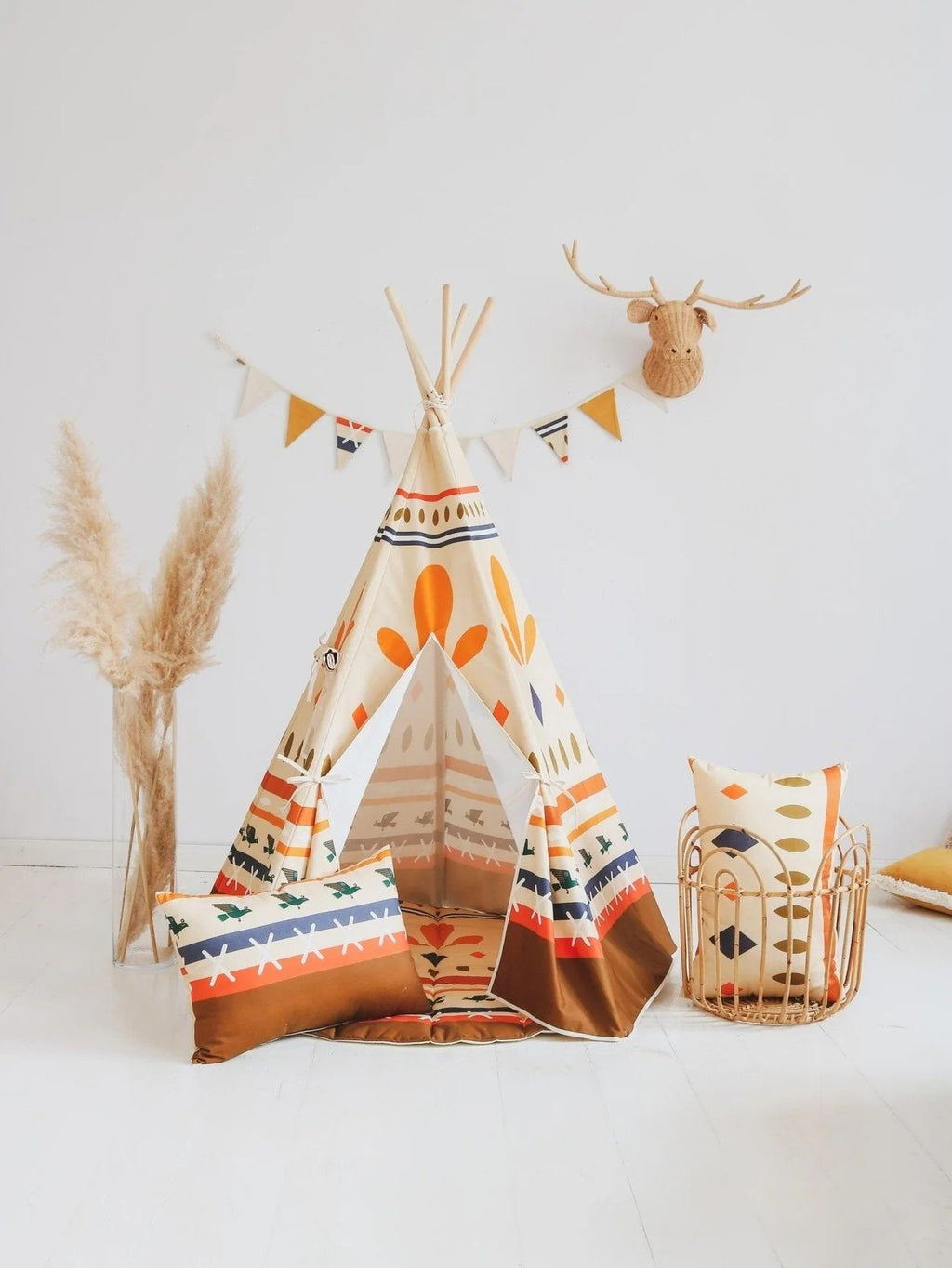 2. Teepee tent with geometric prints and decorative pillows in a minimalistic room