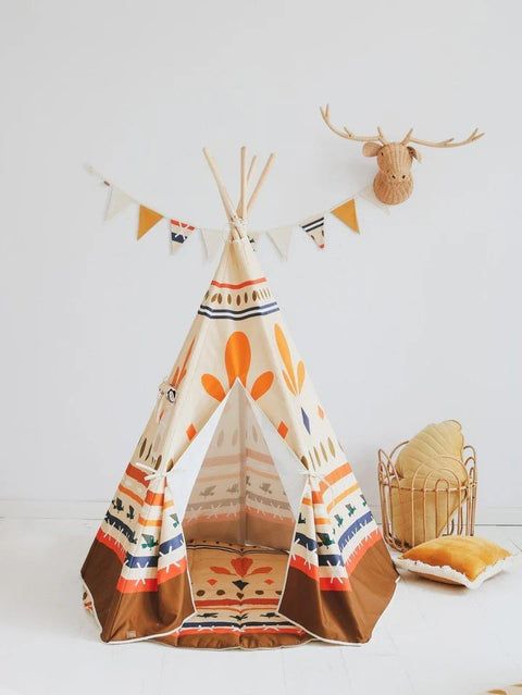 1. Moi Mili teepee tent with geometric prints in a children's room, decorated with a faux deer head and bunting