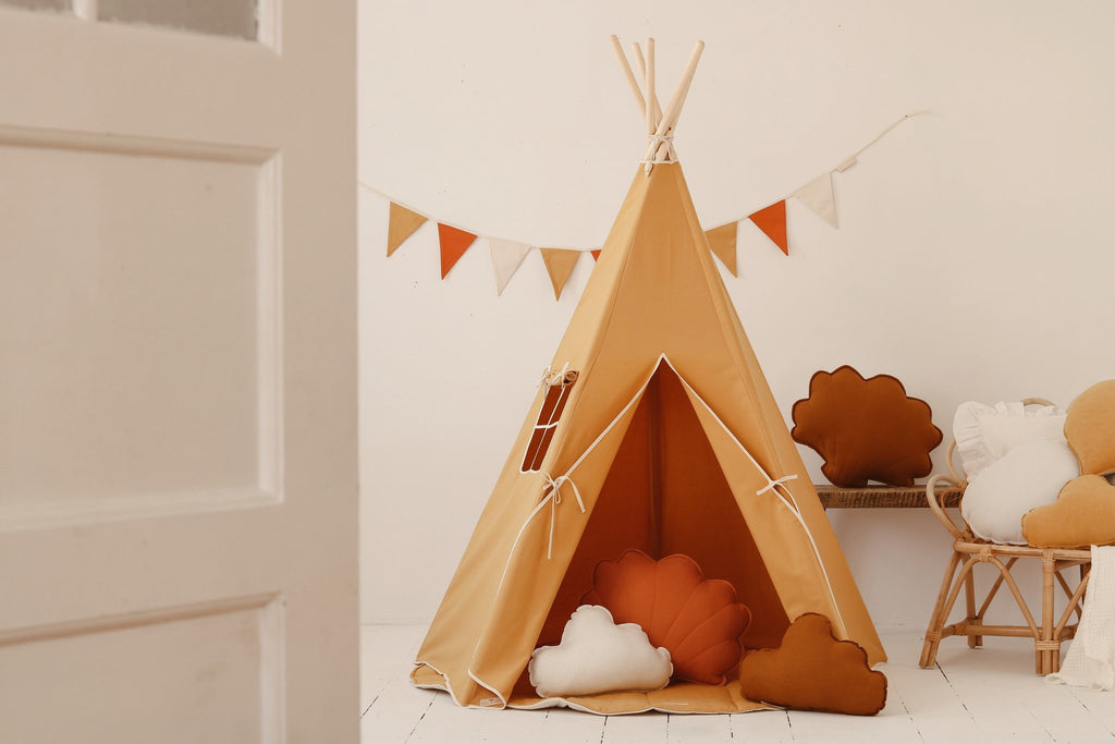 1. Orange teepee tent set up in a cozy indoor space with decorative pillows and bunting, ideal for children's playroom