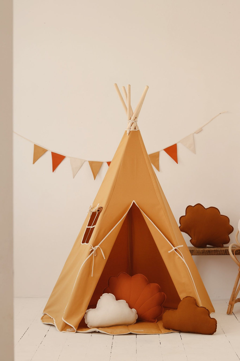 1. Orange teepee tent in a playroom setting with decorative pillows and bunting, perfect for kids