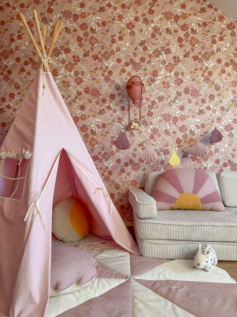 1. Pink teepee tent in children's room with floral wallpaper, cushions, and sofa