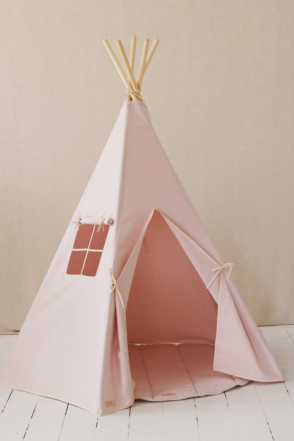 2. Pink teepee tent with open entrance and window, on light wooden floor with beige wall