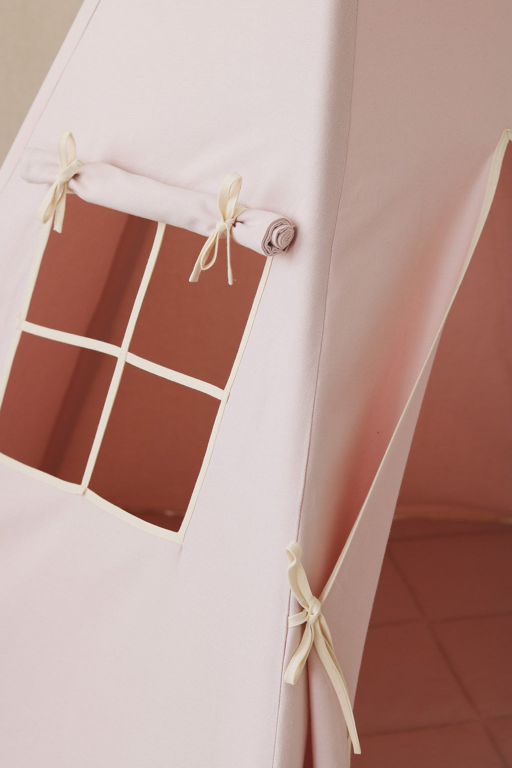 3. Close-up of pink teepee tent window with curtain and tied bows