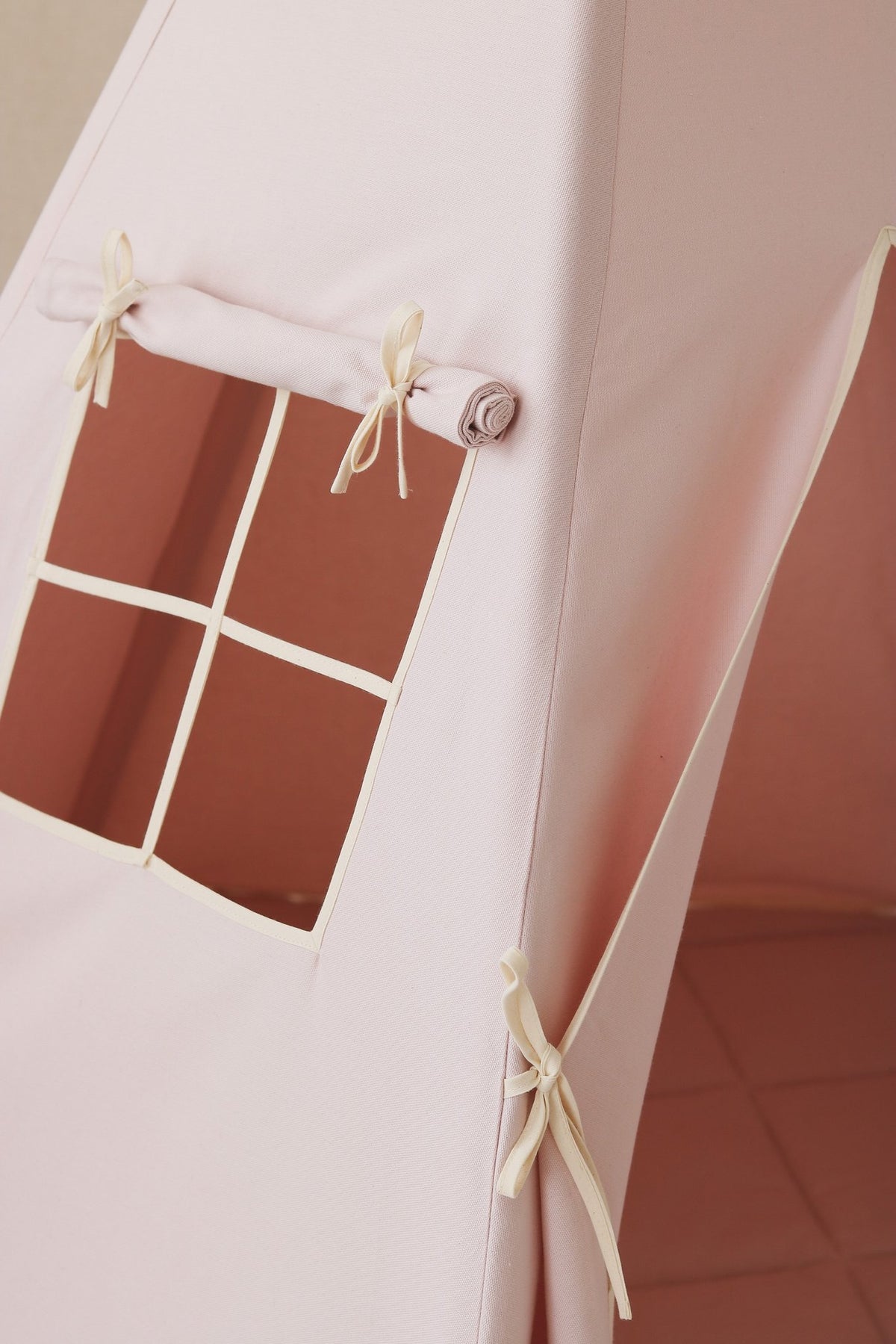 3. Close-up of pink teepee tent window with curtain and tied bows