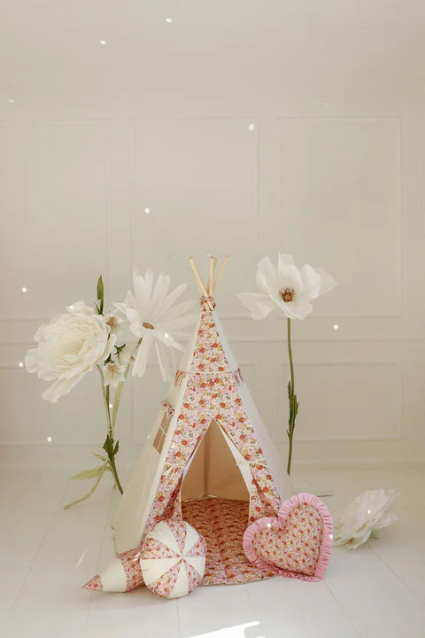 1. Floral teepee tent for children in a light-filled room with decorative flowers and cushions