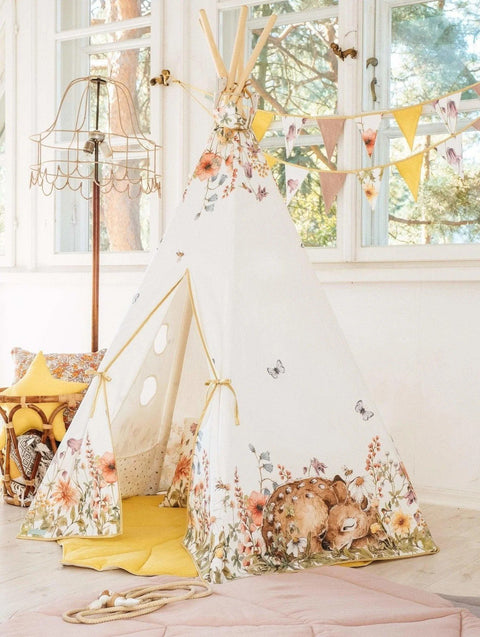 4. Children's teepee tent with floral and deer print, set in a sunlit room with yellow mat and decorative bunting