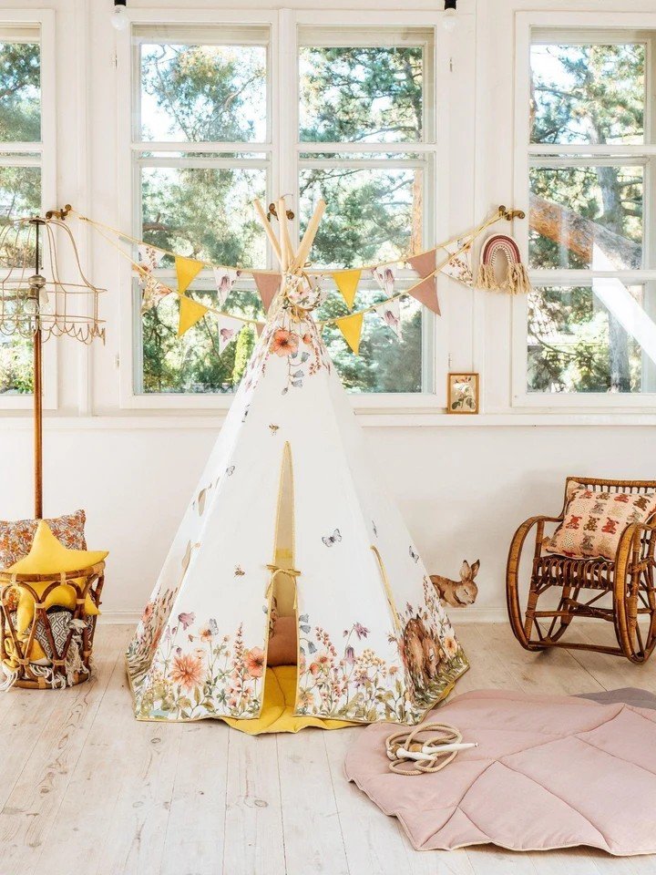 6. Children's teepee tent with wildflower and deer print, styled in a bright room with rocking chair and decorative bunting