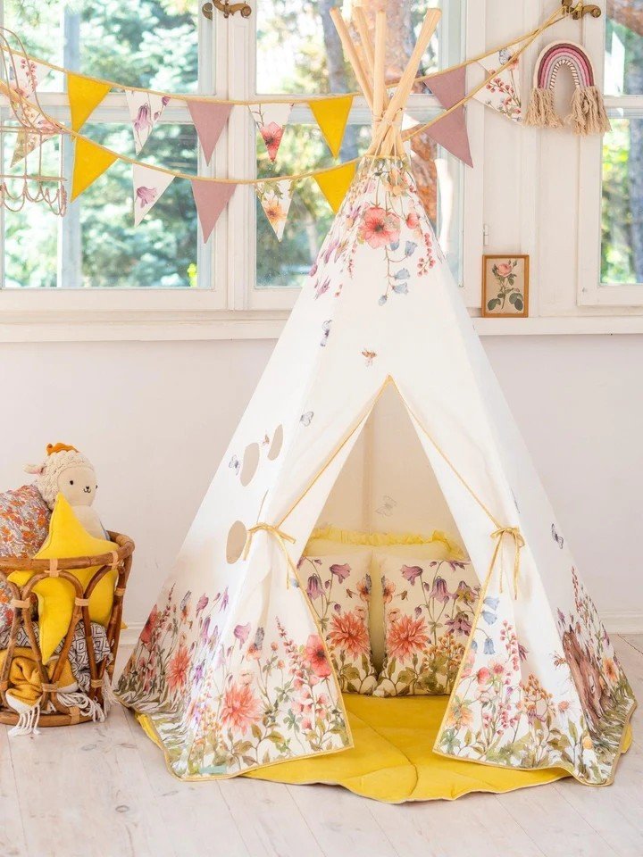 3. Indoor children's teepee tent with wildflower design, yellow mat, and decorative bunting, creating a playful and inviting space