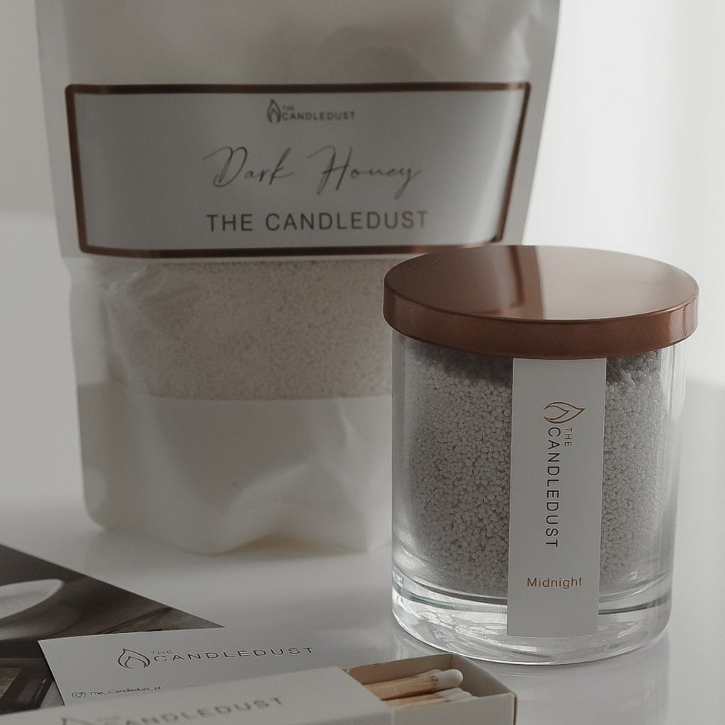 5. Candledust Dark Honey refill kit and Midnight candle jar with matches on a white surface