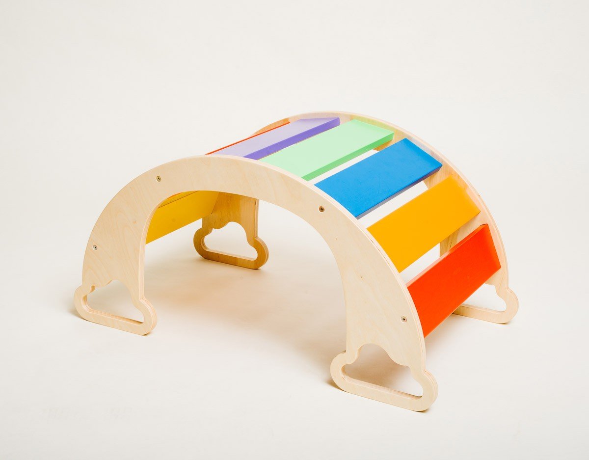 2. Birch plywood rainbow climber with colorful slats on a white background