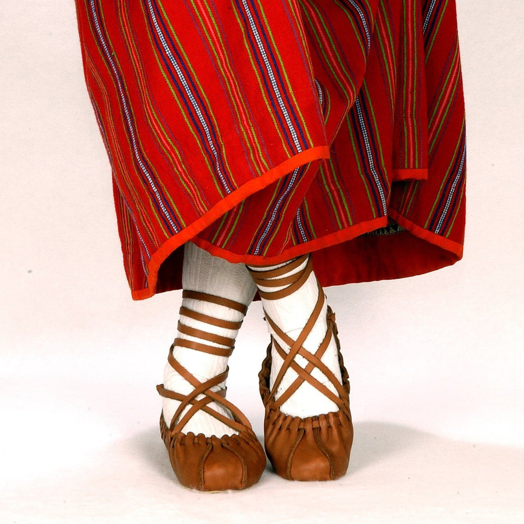 1. Women's upgraded tied dancing shoes by Omaking, styled with traditional red striped dress, shown in lifestyle setting
