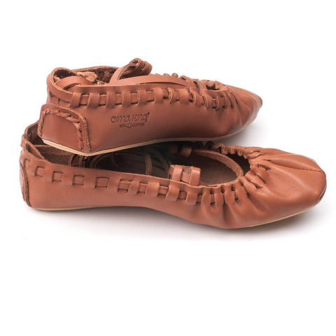 2. Side view of Omaking Tied Dancing Shoes Toots & Teele in brown leather, highlighting braided heel and brand logo
