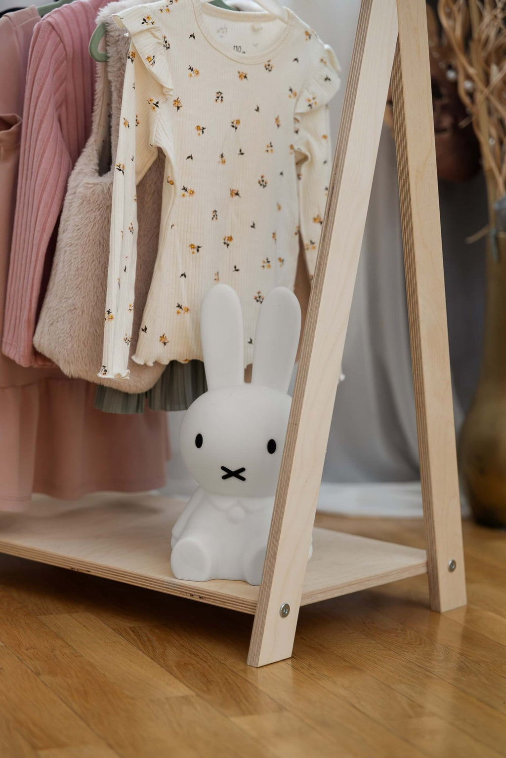 3. Close-up of MeowBaby Tipi clothing rack with children's clothes and a white bunny toy on the shelf