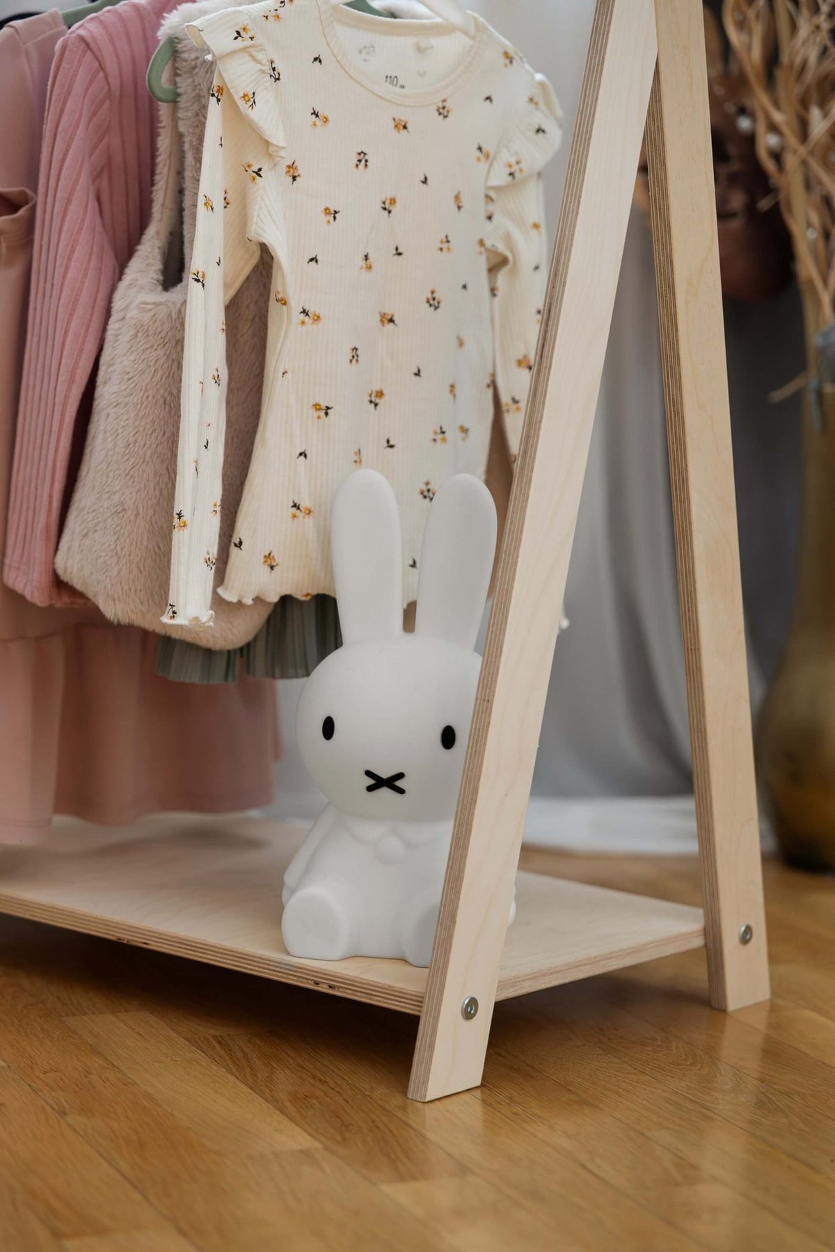 3. Close-up of MeowBaby Tipi clothing rack with children's clothes and a white bunny toy on the shelf