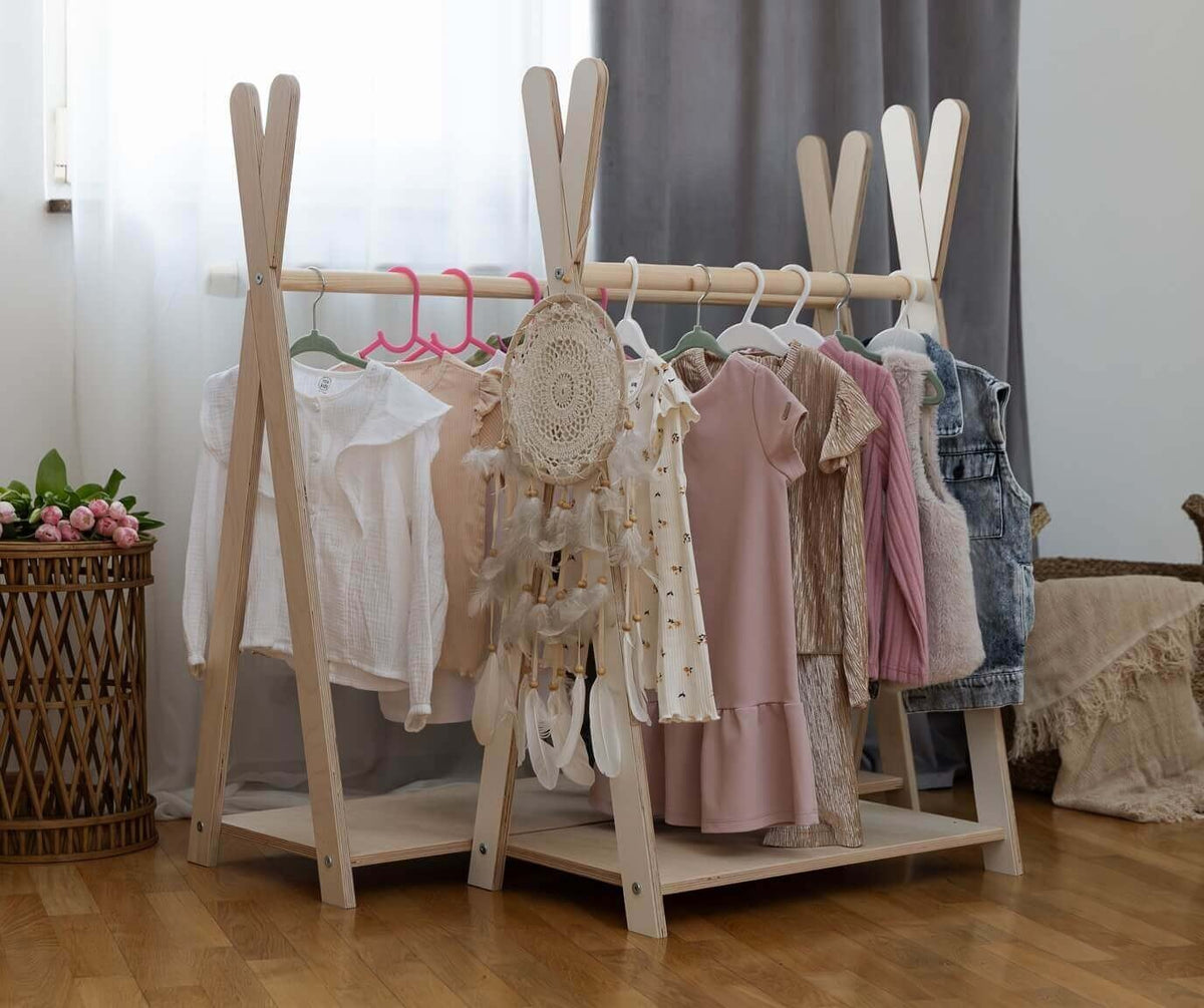 1. Children's room with two MeowBaby Tipi clothing racks holding various kids' clothes and a dreamcatcher