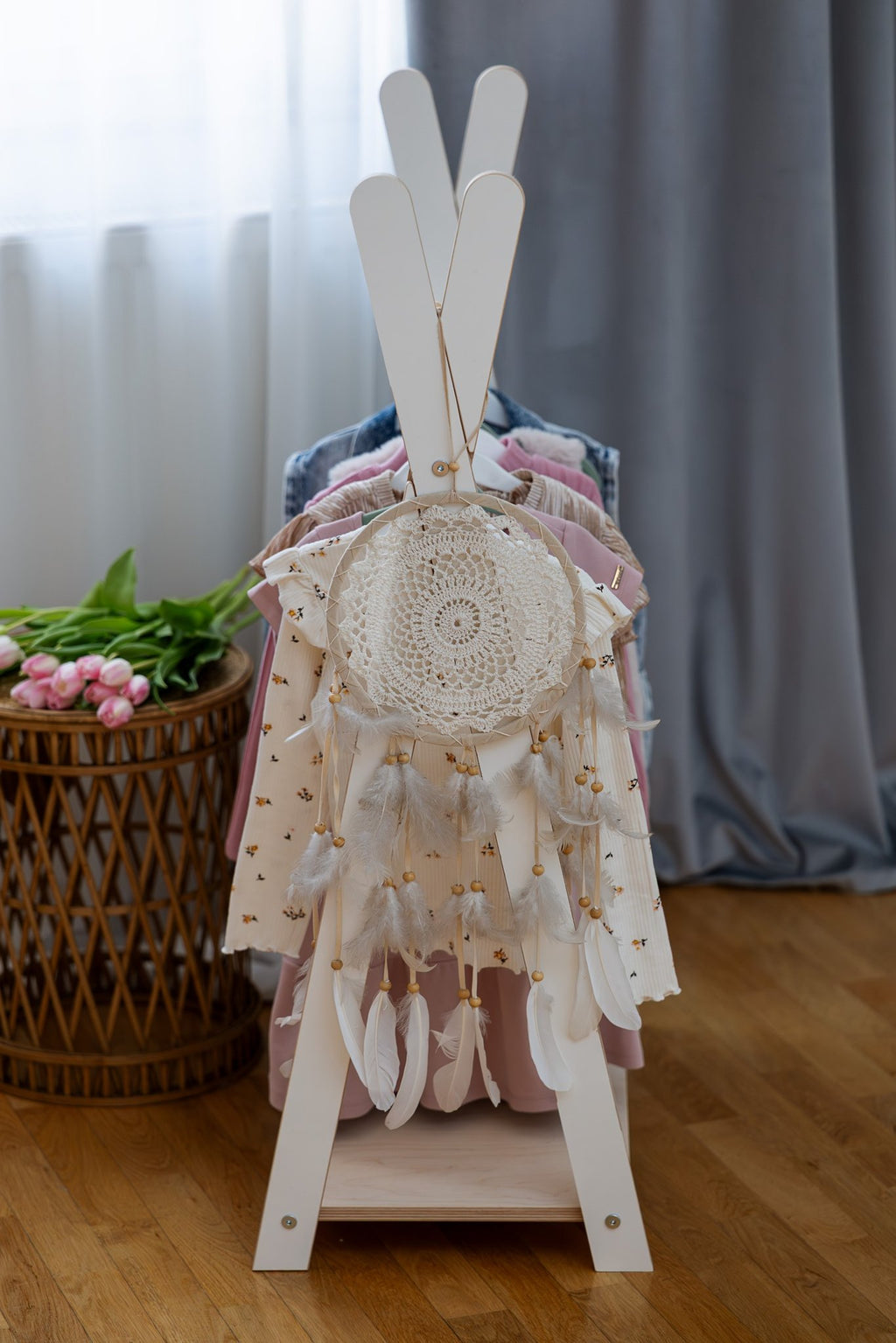 4. Back view of MeowBaby Tipi clothing rack with a dreamcatcher and children's clothes in a room setting