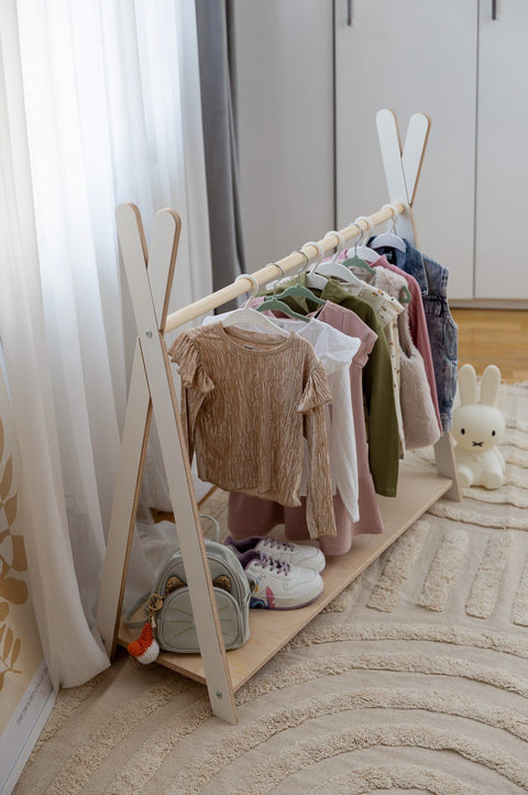 1. MeowBaby Tipi clothing rack in children's room with clothes and shoes, featuring white and wood design
