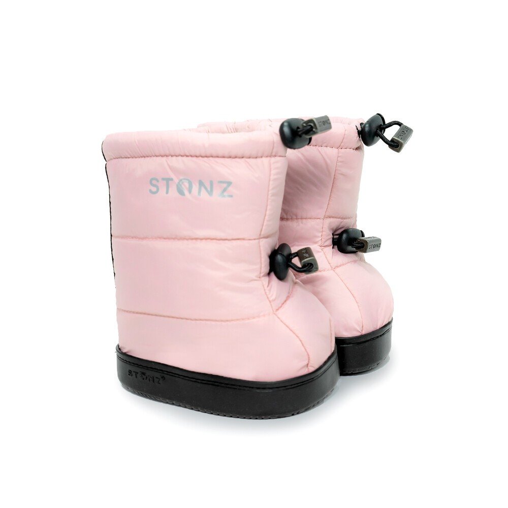 3. Stonz haze pink toddler puffer booties with adjustable fasteners and black soles in studio