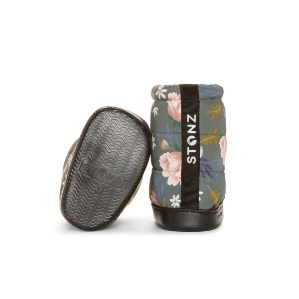 3. Back view of Stonz toddler puffer booties in woodland print with floral design, highlighting non-slip rubber sole and brand logo