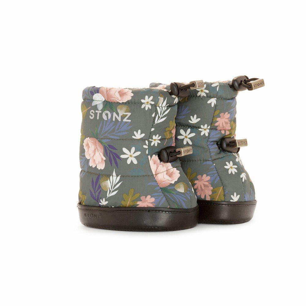 1. Stonz toddler puffer booties in woodland print with floral design, featuring adjustable fasteners and non-slip rubber soles, shown in a studio setting