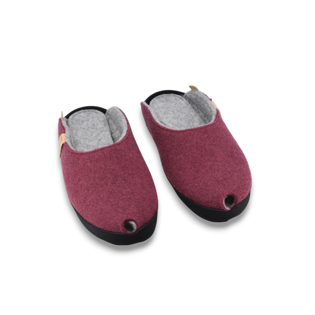 2. Pair of burgundy lambswool felt slippers with black microfibre sole, front view highlighting rounded toe design