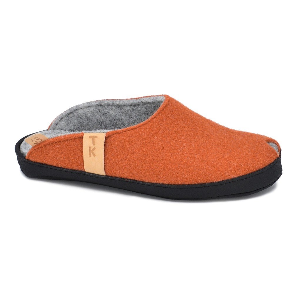 2. Terracotta lambswool felt slippers with black microfibre sole, side view showing TK logo tag
