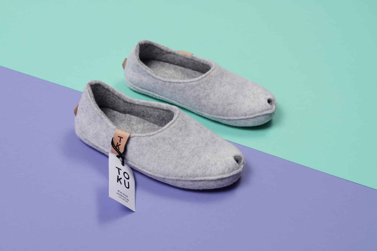 2. Studio shot of TOKU Budapest slippers in white lambswool felt with peek-hole design and arch support insole