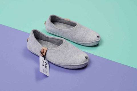 2. Studio shot of TOKU Budapest slippers in white lambswool felt with peek-hole design and arch support insole