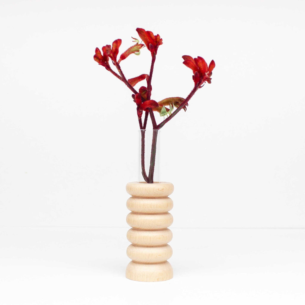 1. Totem Wooden Vase - Medium Nº 1 by 5mm Paper with red flowers, showcasing beech wood base and glass tube in a minimalist setting