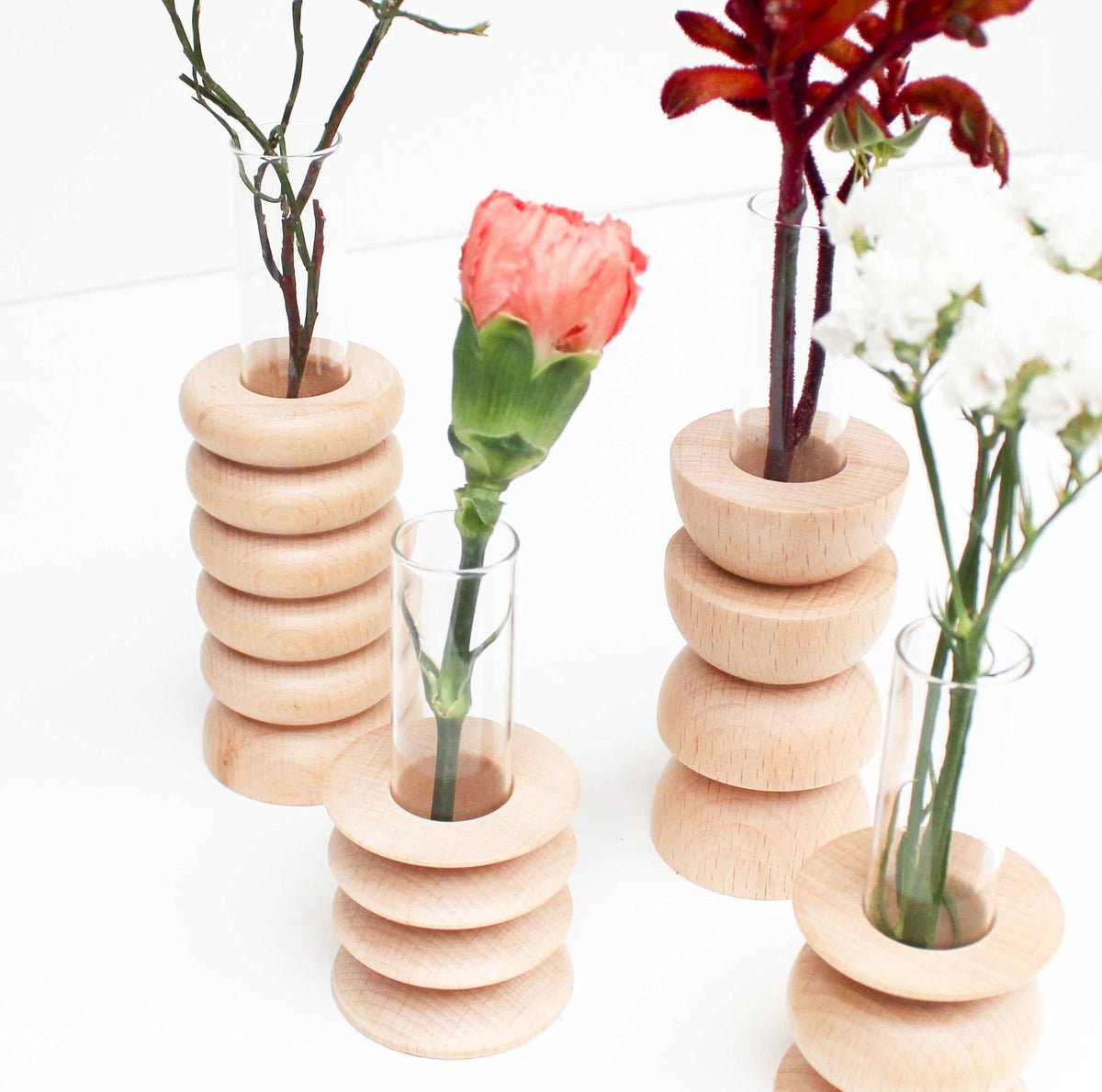 2. Group of Totem Wooden Vases - Medium Nº 2 by 5mm Paper, showcasing beech wood and glass tube design
