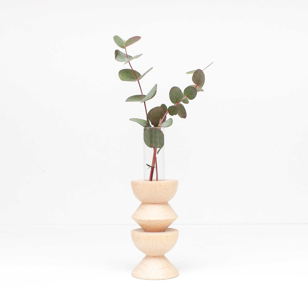 4. Studio shot of Totem Wooden Vase by 5mm Paper with eucalyptus, highlighting beech wood and glass tube