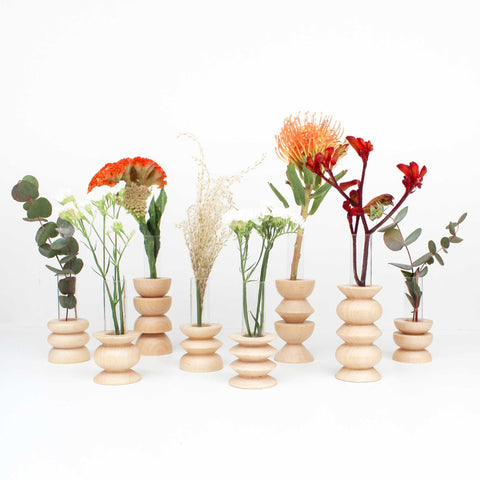 3. Collection of Totem Wooden Vases by 5mm Paper with various flowers, studio setting