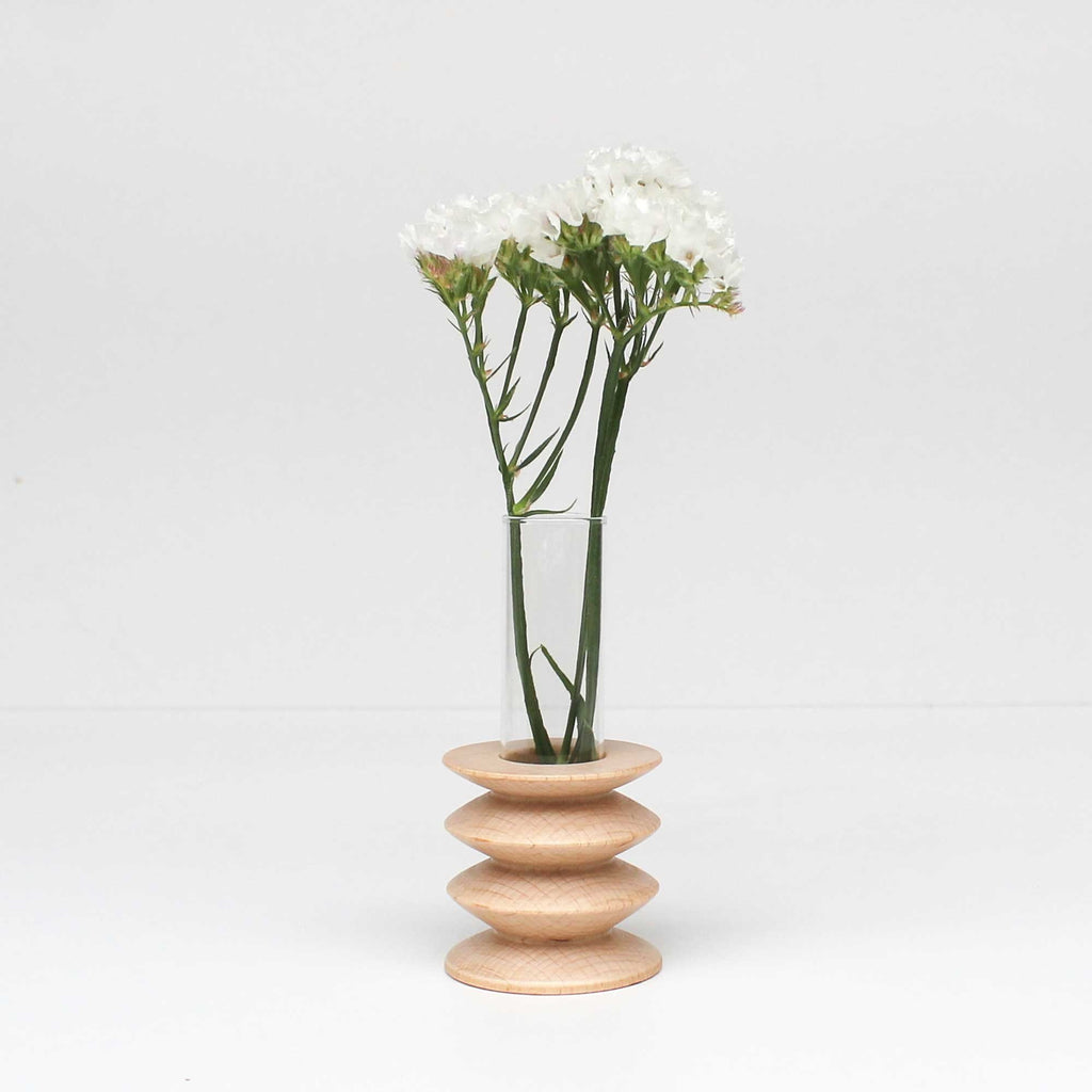 2. Studio shot of Totem Wooden Vase - Short Nº 2 by 5mm Paper, featuring beech wood base and glass tube with white flowers