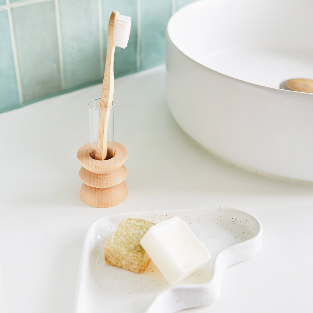 1. Totem Wooden Vase - Short Nº 3 by 5mm Paper used as a toothbrush holder in a modern bathroom setting