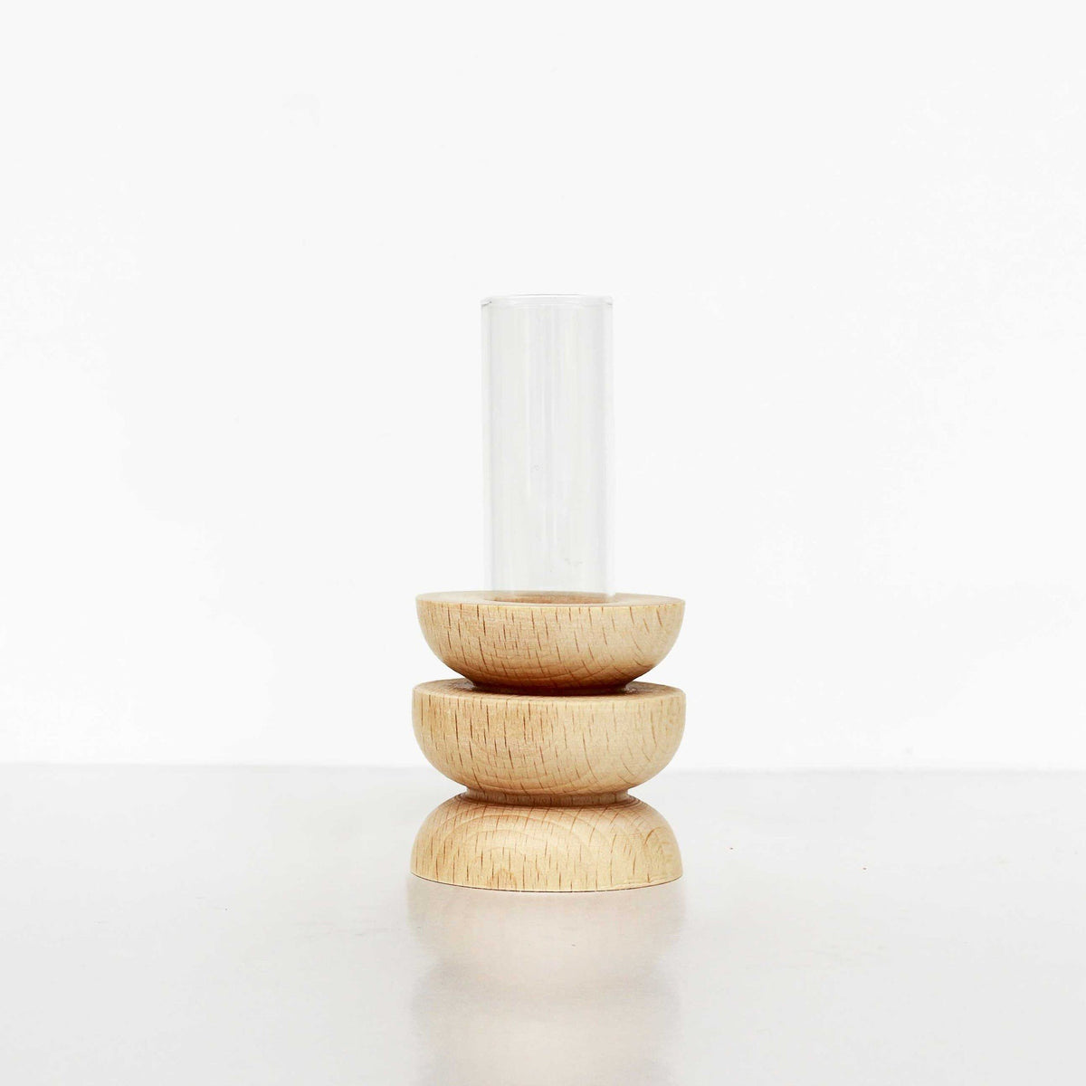 4. Studio image of Totem Wooden Vase - Short Nº 4 by 5mm Paper showing beech wooden base and glass tube