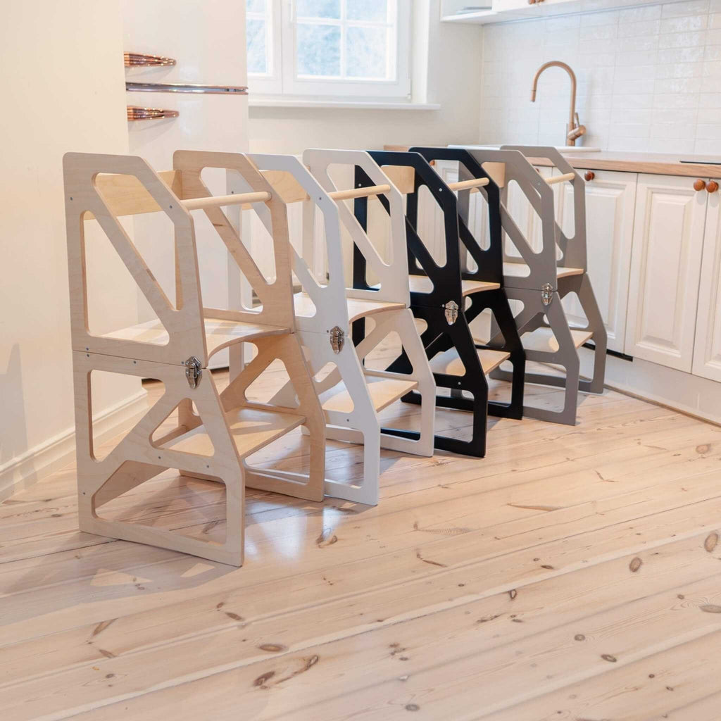 1. Four transformable kitchen towers in natural, white, black, and gray colors lined up in a modern kitchen