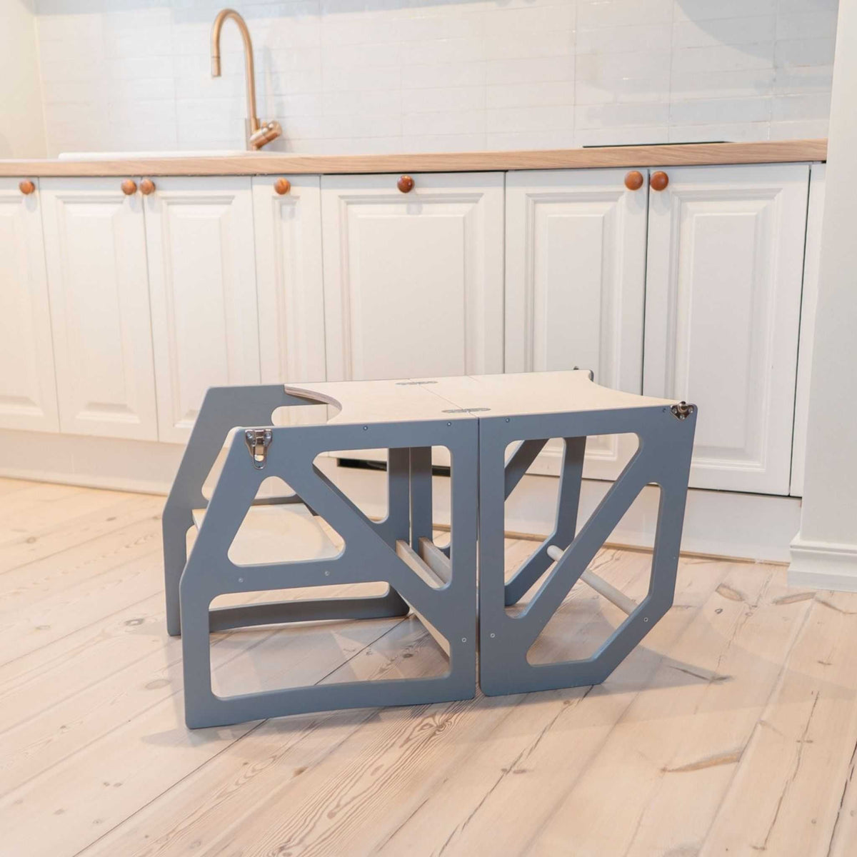 4. Gray transformable kitchen tower folded into table and chair set in kitchen